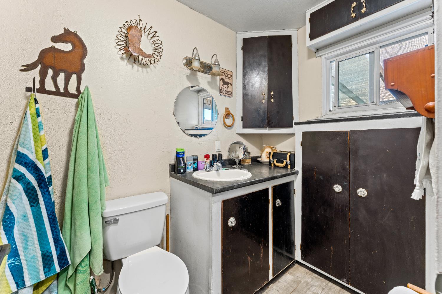 5912 Grove Avenue Marysville, CA 95901 - Photo 18 of 23 a bathroom with a granite countertop sink and a mirror