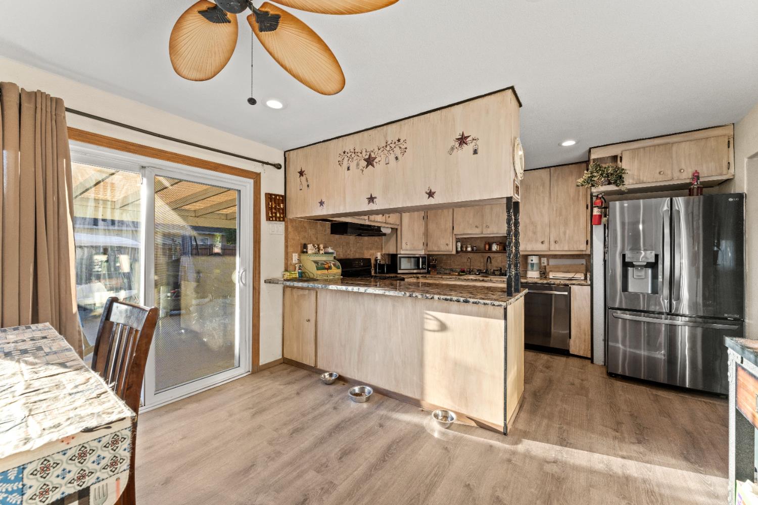 5912 Grove Avenue Marysville, CA 95901 - Photo 6 of 23 a kitchen with stainless steel appliances granite countertop a refrigerator and a stove top oven