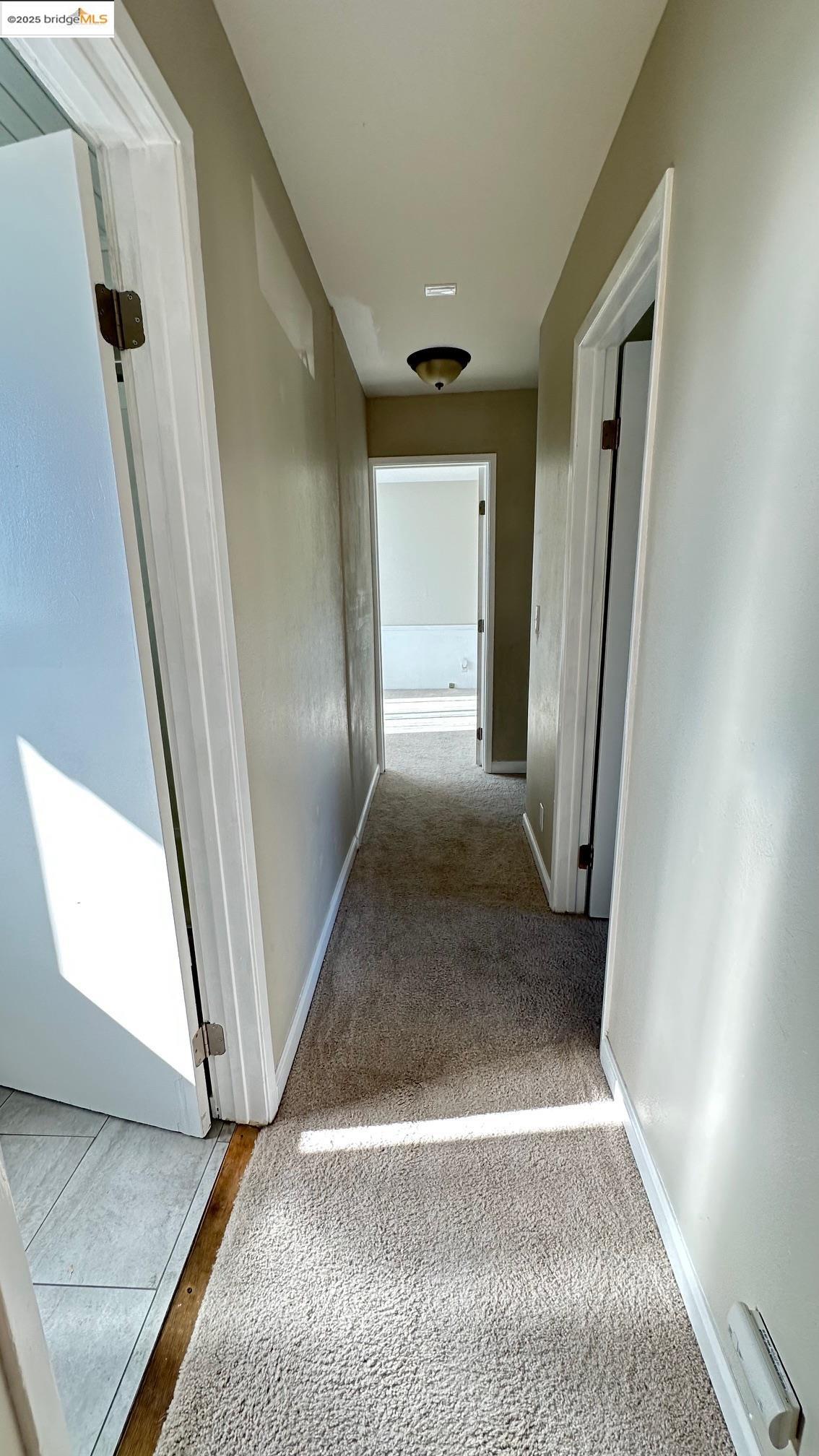 840 Key Rte Boulevard Albany, CA 94706 - Photo 24 of 29 Hallway with carpet floors and baseboards