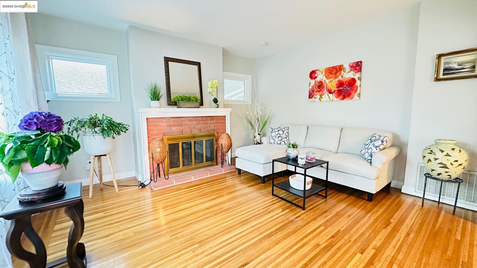 840 Key Rte Boulevard Albany, CA 94706 - Photo 4 of 29 Living room with wood finished floors and a fireplace