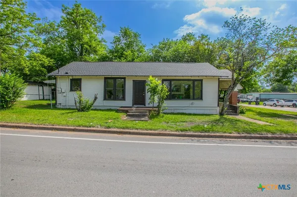 a front view of a house with a yard