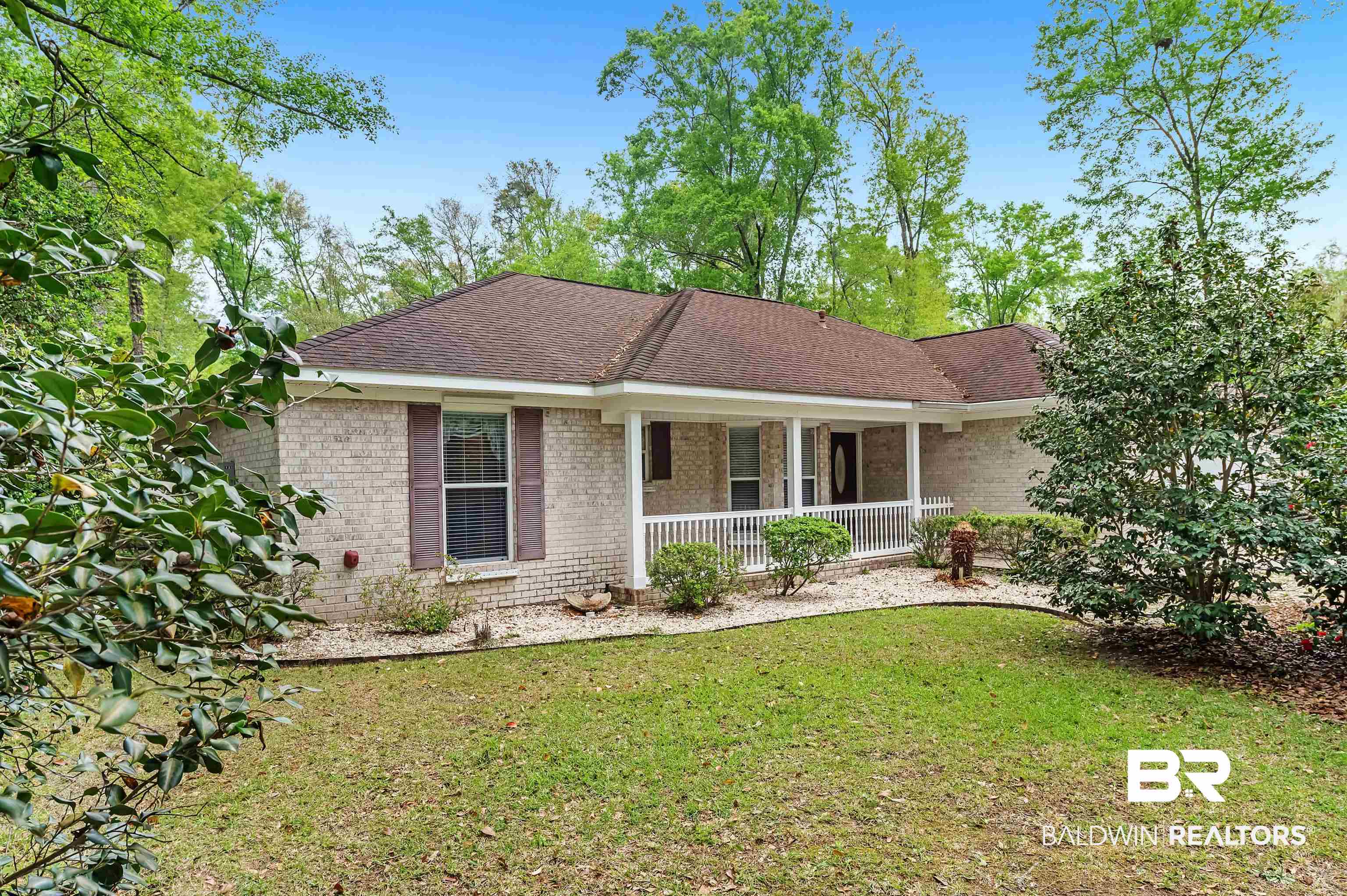 9908 Clarke Ridge Road Foley, AL 36535 - Photo 1 of 56 Single story home featuring a front lawn, a porch, brick siding, and roof with shingles