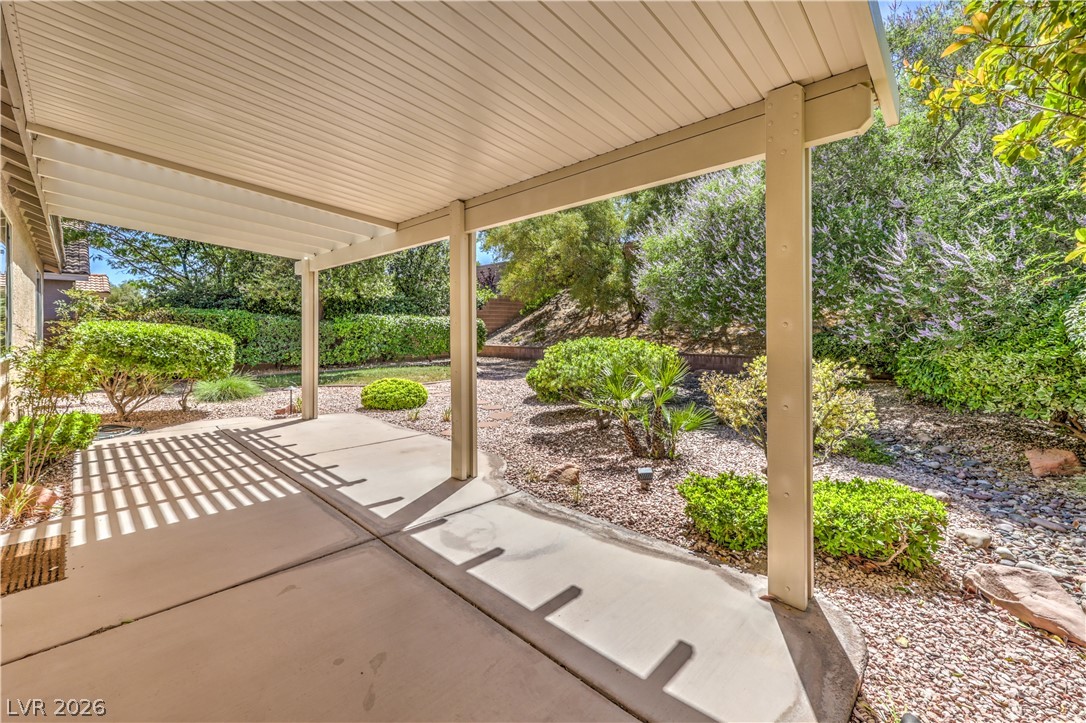 3713 Spring Shadow Road Las Vegas, NV 89129 - Photo 33 of 37 An inviting covered patio offers ample space for outdoor enjoyment and overlooks a neatly landscaped backyard.