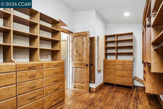 a view of walk in closet with empty racks