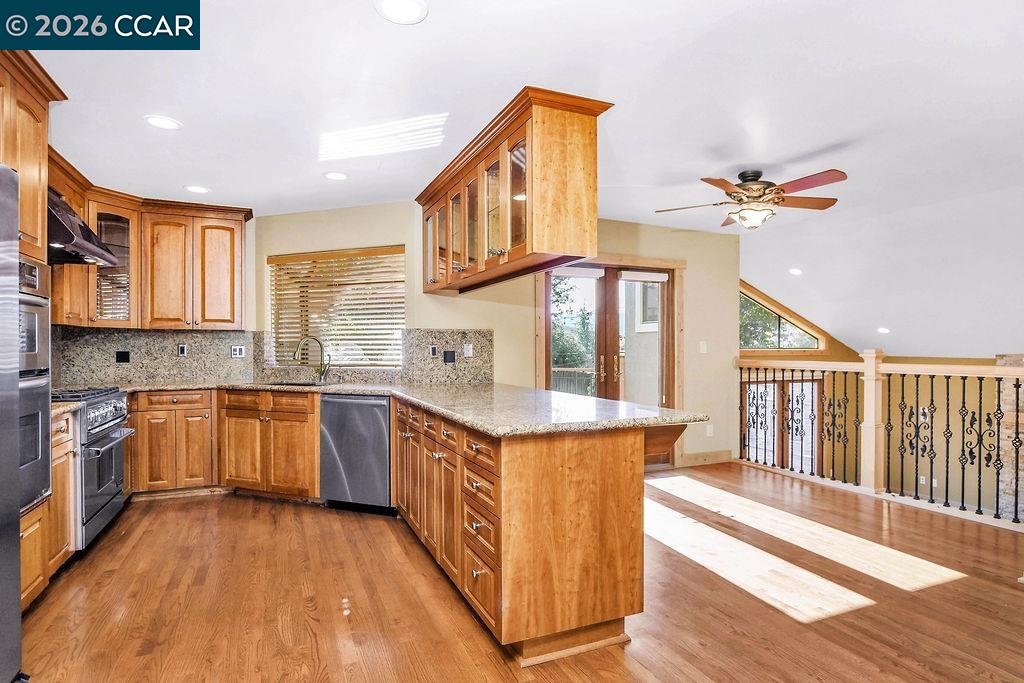 5308 Vista Point Court Concord, CA 94521 - Photo 27 of 56 a kitchen with stainless steel appliances granite countertop a stove a sink dishwasher and a cabinets with wooden floor