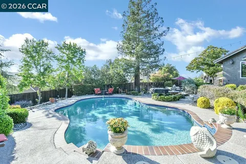 a swimming pool with outdoor seating and yard