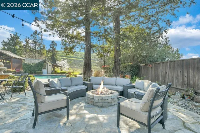 a view of backyard with seating space and trees