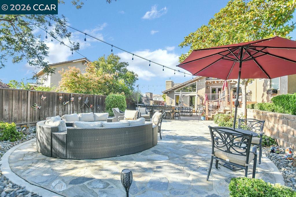 5308 Vista Point Court Concord, CA 94521 - Photo 50 of 56 a view of a patio with couches table and chairs under an umbrella