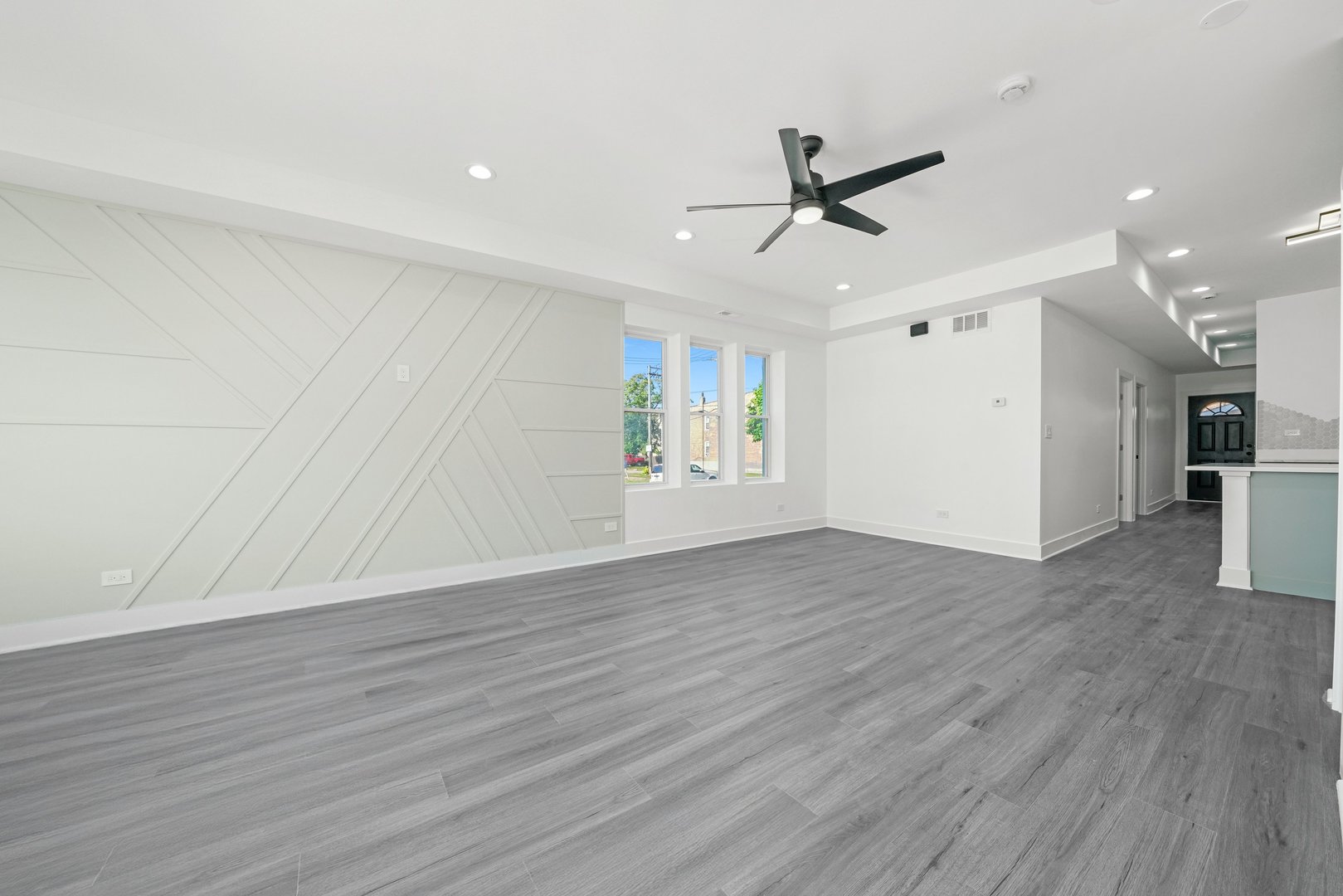 322 South Kostner Avenue Chicago, IL 60624 - Photo 13 of 35 a view of an empty room with wooden floor and a ceiling fan