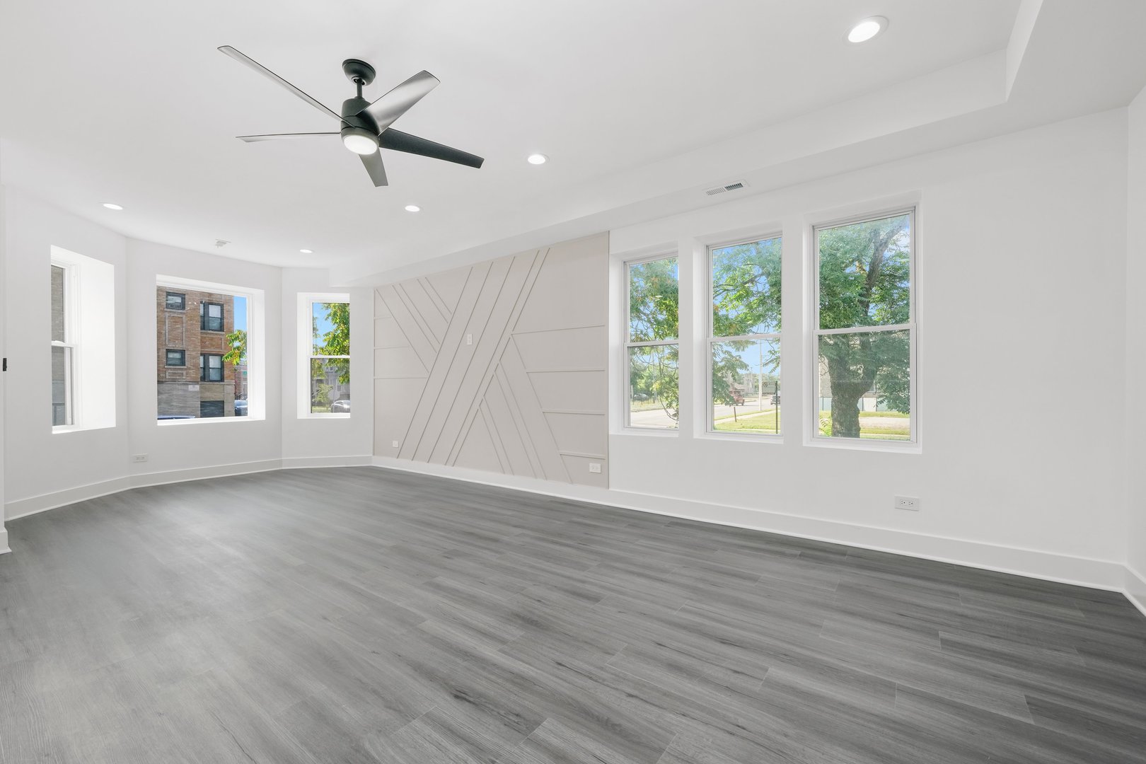 322 South Kostner Avenue Chicago, IL 60624 - Photo 14 of 35 a view of empty room with wooden floor and fan