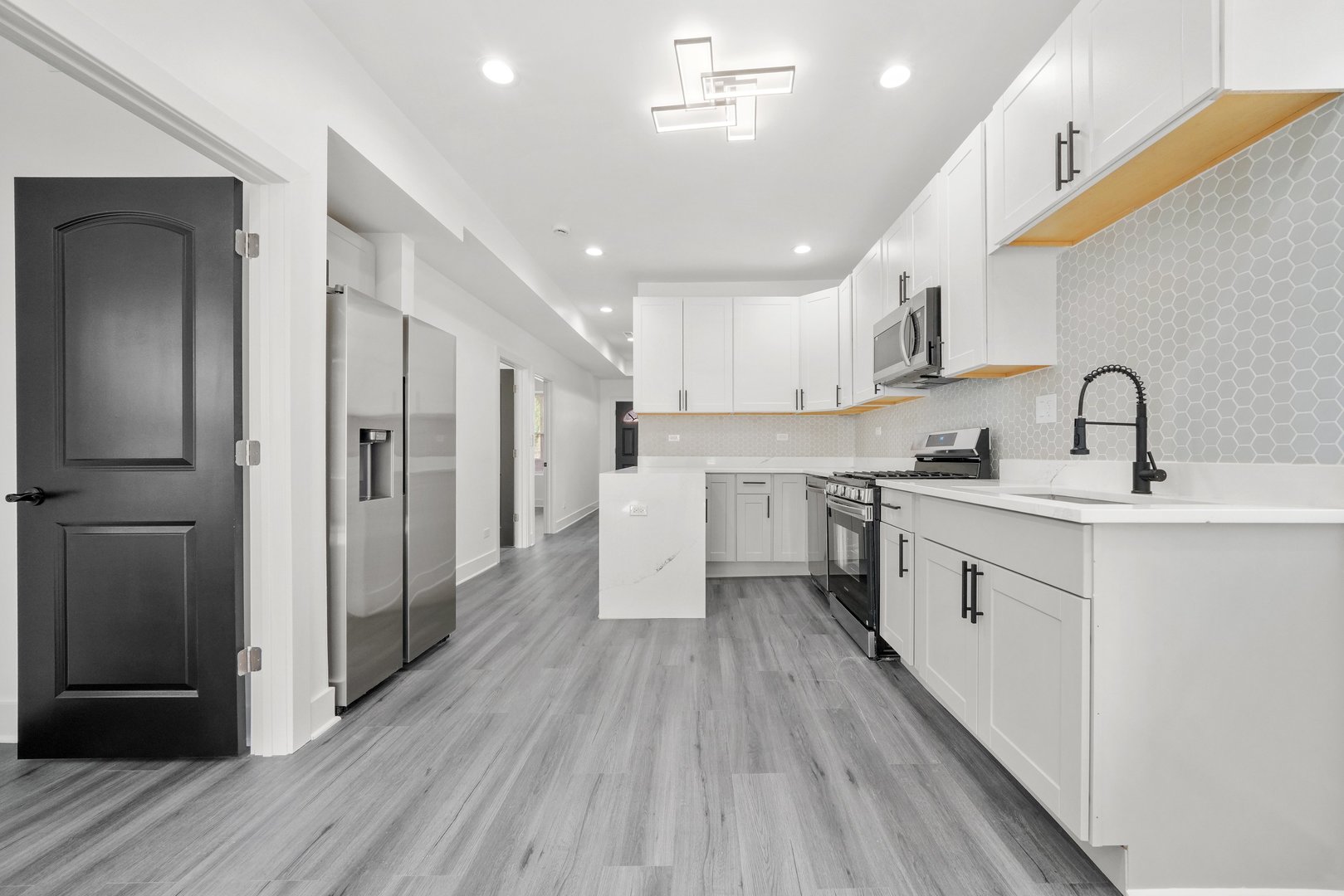 322 South Kostner Avenue Chicago, IL 60624 - Photo 18 of 35 a kitchen with white cabinets and stainless steel appliances