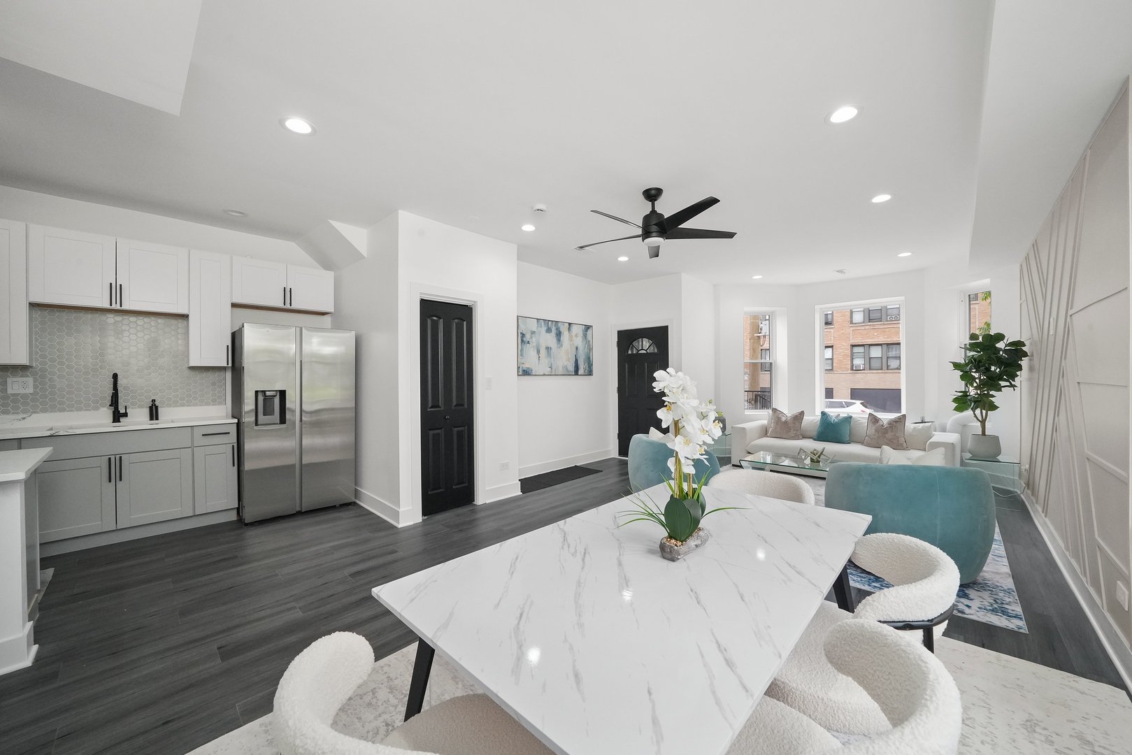 322 South Kostner Avenue Chicago, IL 60624 - Photo 5 of 35 a large white kitchen with a refrigerator a stove a sink a dining table and chairs