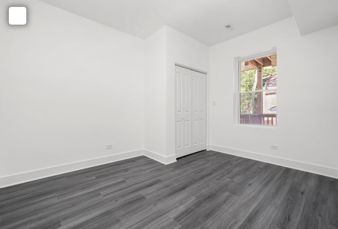 322 South Kostner Avenue Chicago, IL 60624 - Photo 8 of 35 an empty room with wooden floor and window