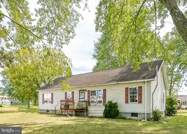 a backyard of a house with yard table and chairs