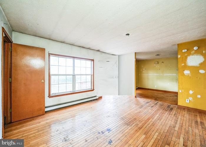 62 Hillview Lane Tioga, PA 16946 - Photo 7 of 13 a view of an empty room with wooden floor and a window