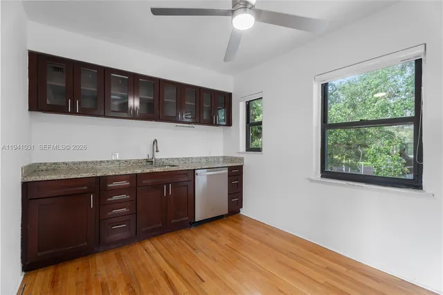 a kitchen with stainless steel appliances granite countertop cabinets and wooden floor