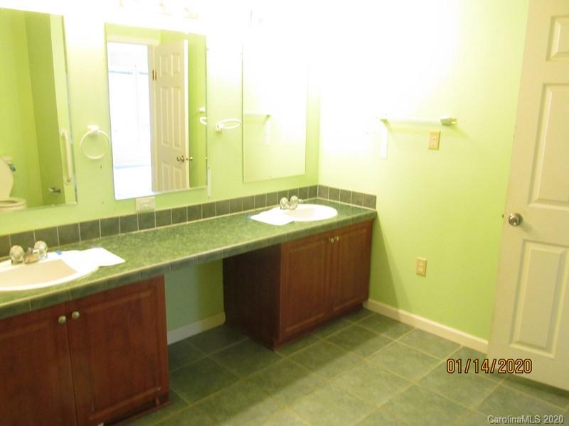 939 A Pinckney Road Chester, SC 29706 - Photo 13 of 14 a bathroom with a granite countertop sink and a mirror