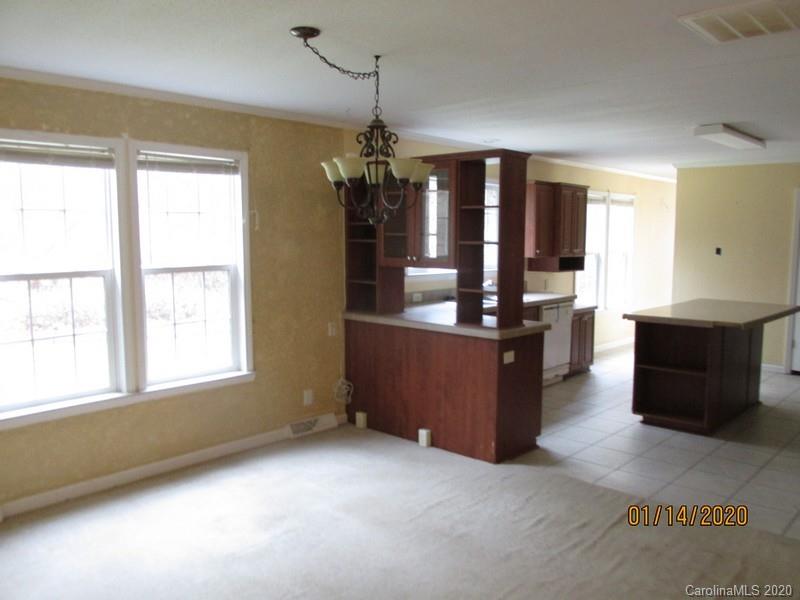 939 A Pinckney Road Chester, SC 29706 - Photo 8 of 14 a kitchen with granite countertop a refrigerator and a sink