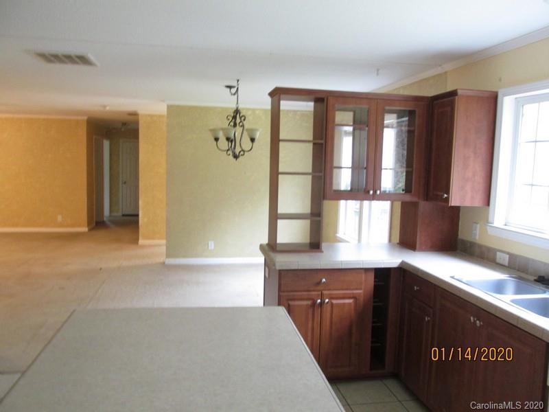 939 A Pinckney Road Chester, SC 29706 - Photo 10 of 14 a kitchen with granite countertop a sink and a stove