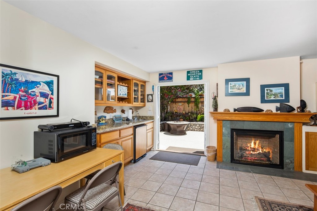 181 Sunset Terrace Laguna Beach, CA 92651 - Photo 13 of 54 First level family Room with Fireplace. Doors to Backyard