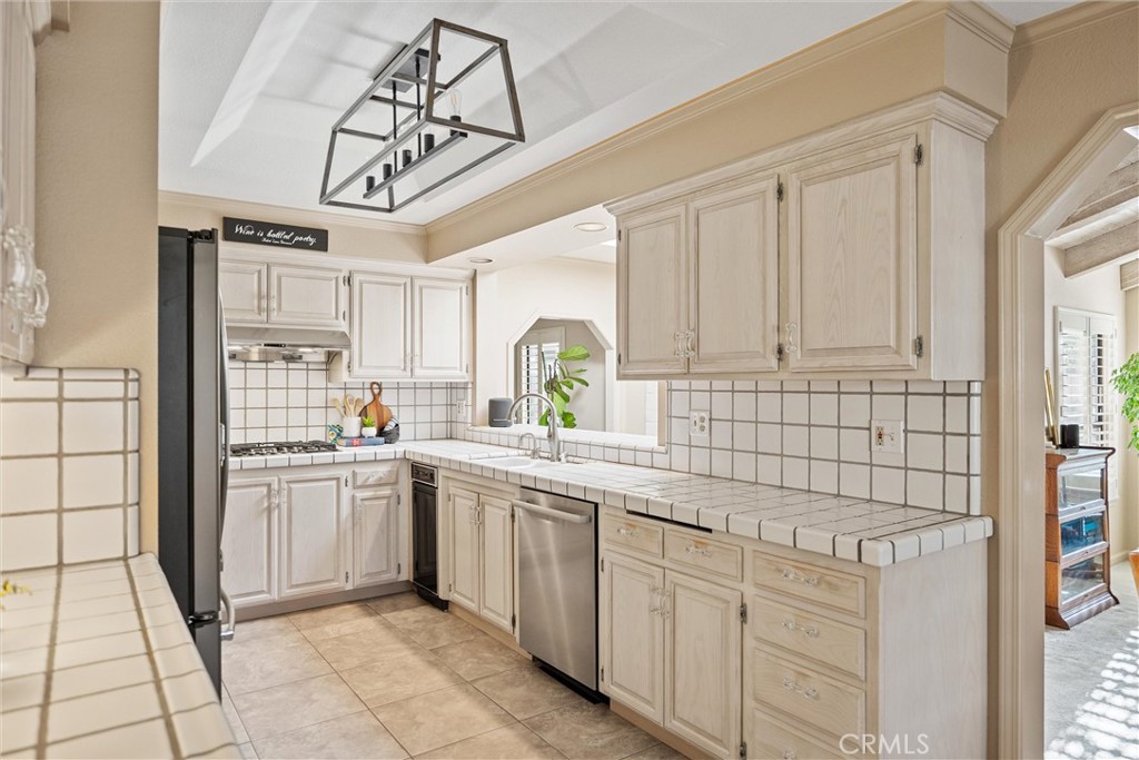 529 Countryside Lane Chico, CA 95973 - Photo 20 of 51 a kitchen with cabinets appliances a sink and a window