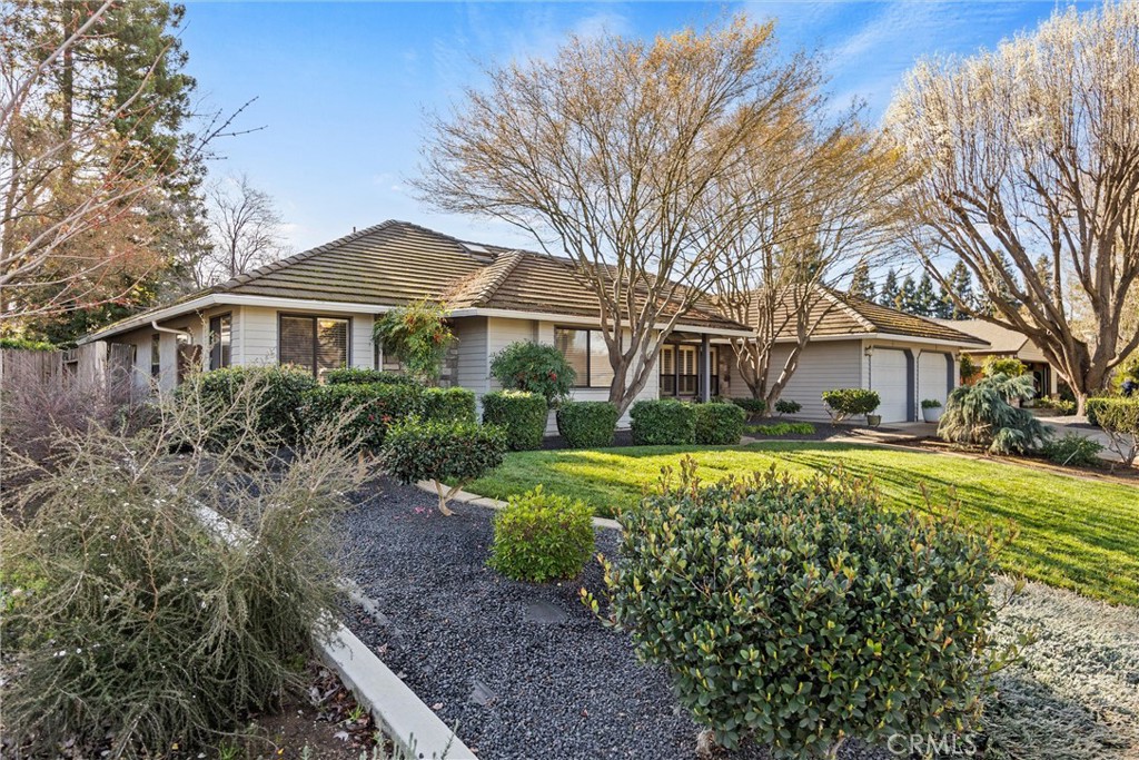 529 Countryside Lane Chico, CA 95973 - Photo 2 of 51 a front view of a house with a yard table and chairs