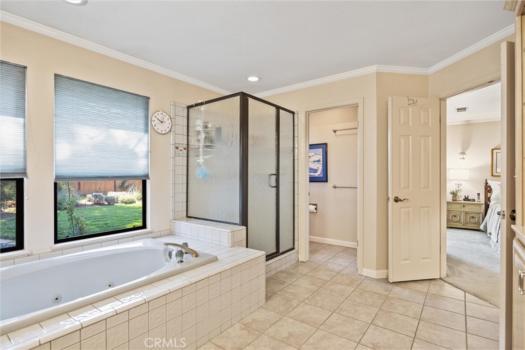 529 Countryside Lane Chico, CA 95973 - Photo 29 of 51 a spacious bathroom with a mirror a bathtub and a shower