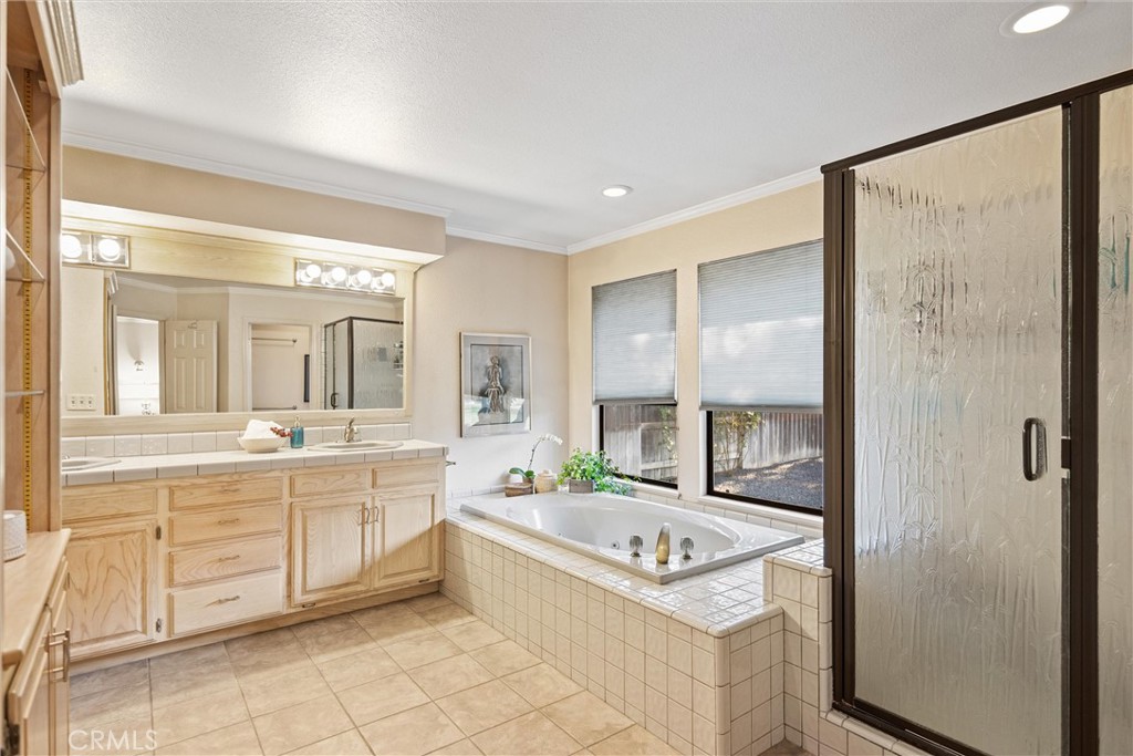 529 Countryside Lane Chico, CA 95973 - Photo 30 of 51 a spacious bathroom with a granite countertop tub sink and mirror