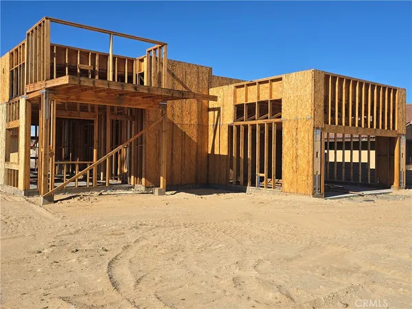 a view of a house with wooden fence