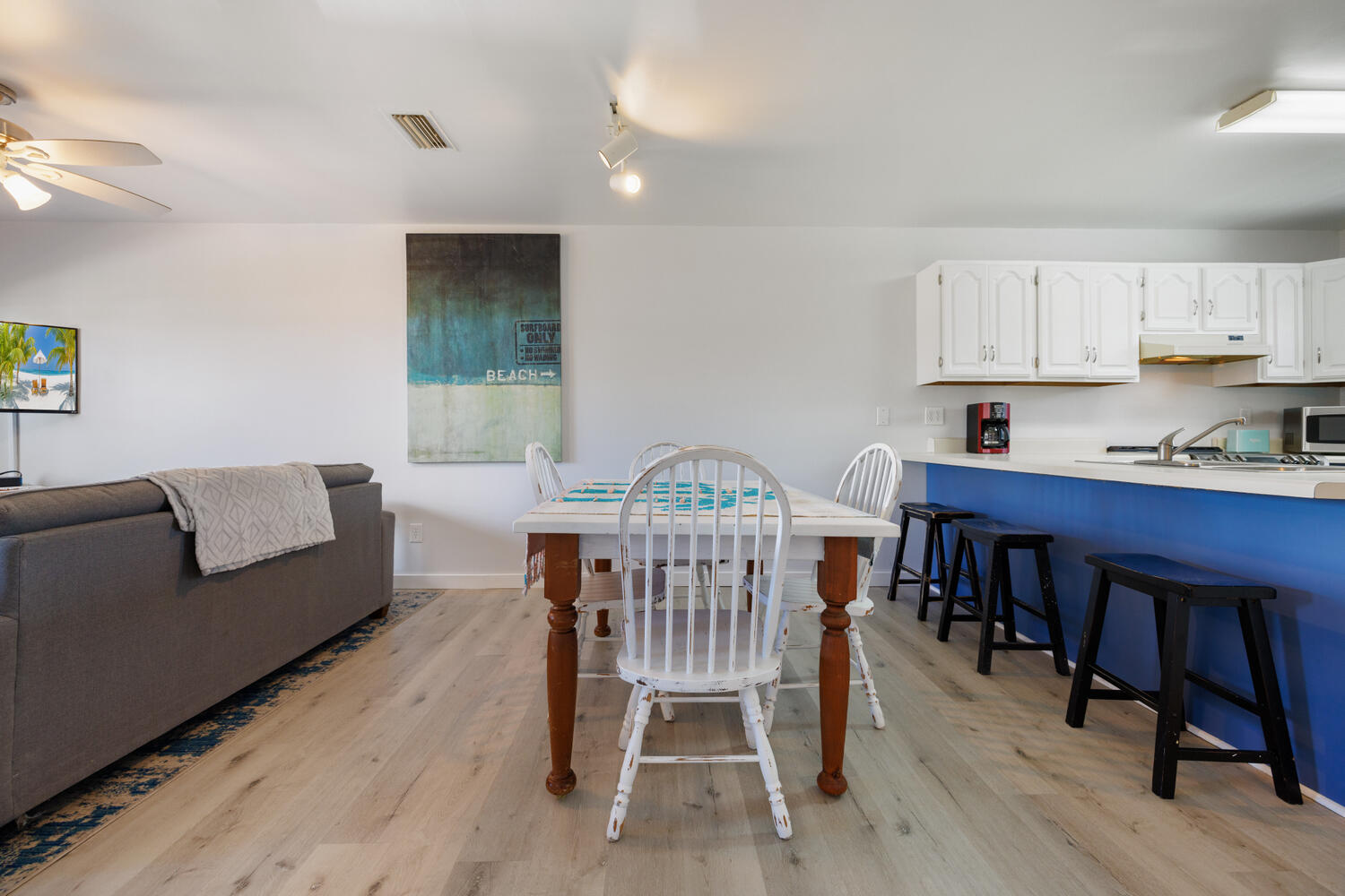 145 Cain Road Panama City Beach, FL 32413 - Photo 19 of 60 a view of a dining room with furniture and wooden floor