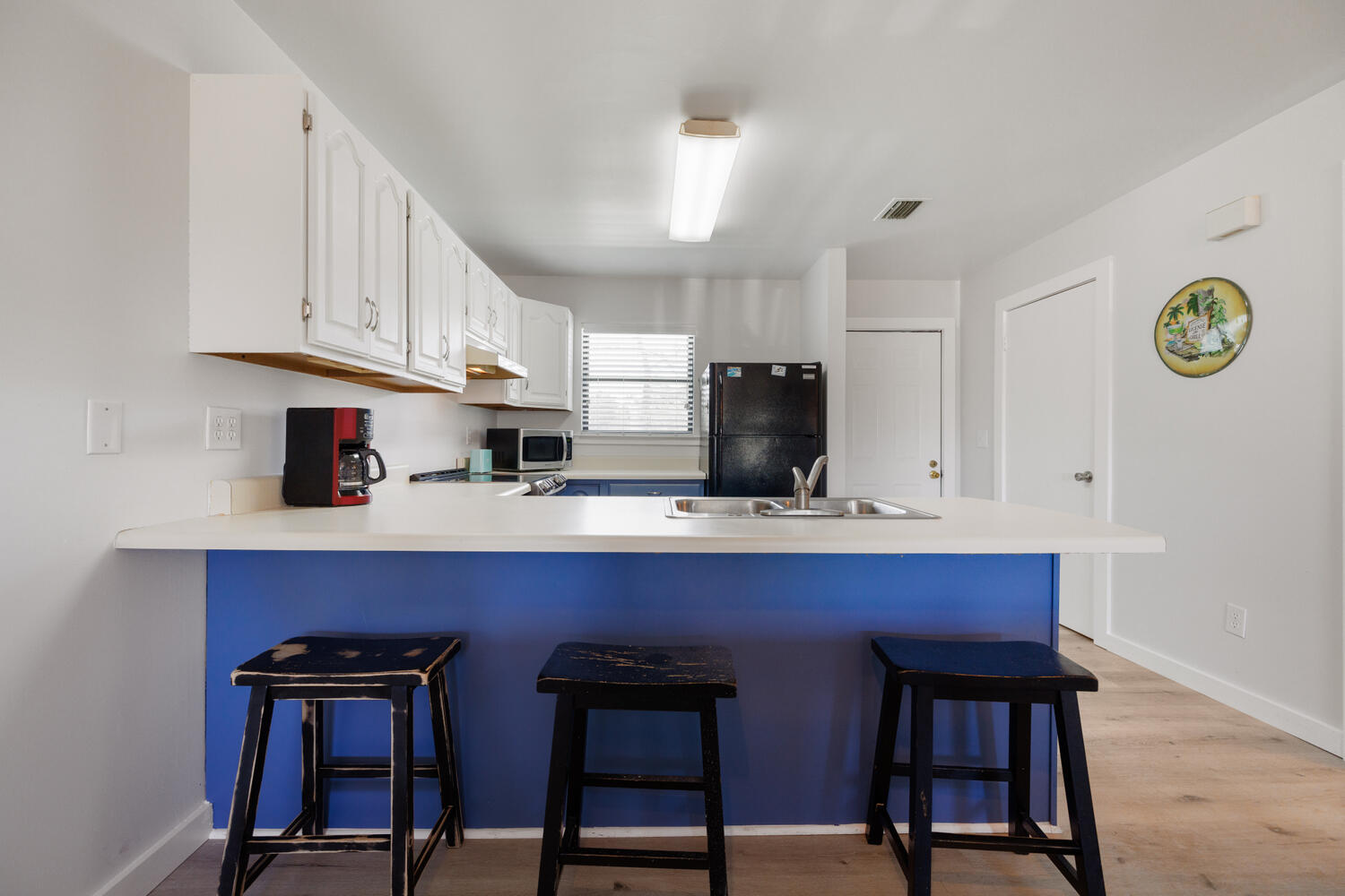 145 Cain Road Panama City Beach, FL 32413 - Photo 20 of 60 a kitchen with stainless steel appliances a table chairs refrigerator and cabinets