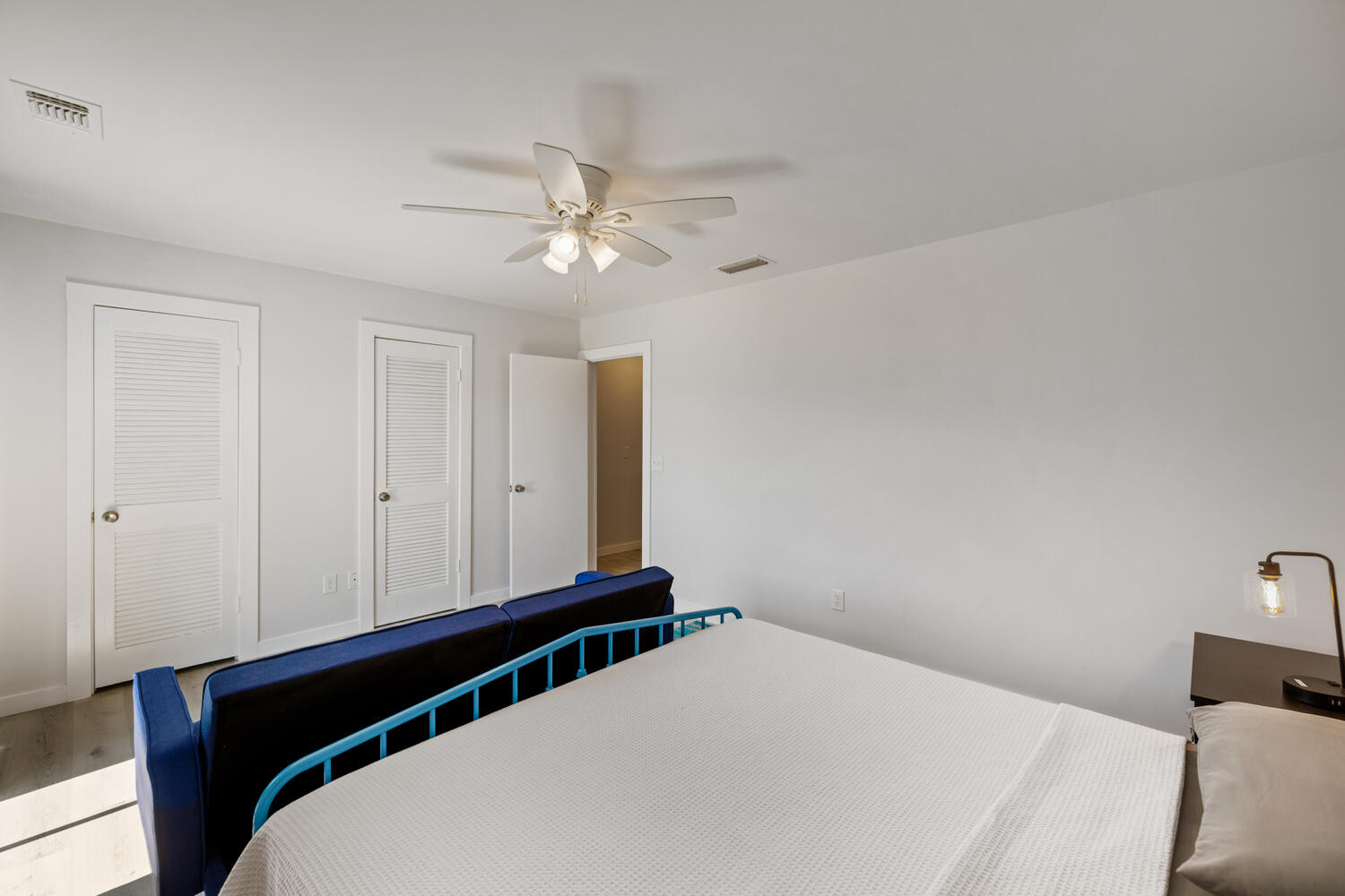 145 Cain Road Panama City Beach, FL 32413 - Photo 30 of 60 a bedroom with a bed and a ceiling fan