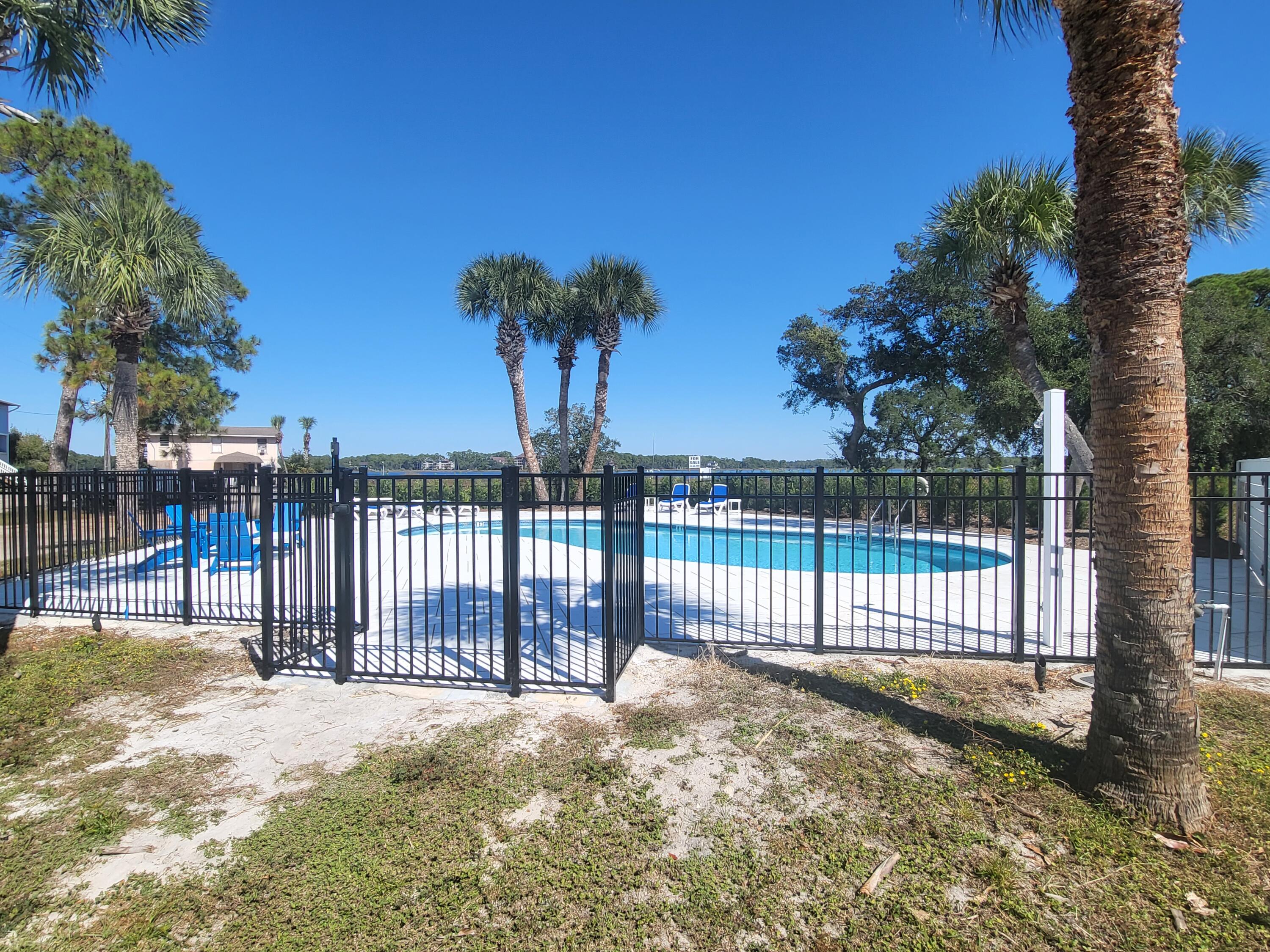 145 Cain Road Panama City Beach, FL 32413 - Photo 3 of 60 a view of a backyard with a trees