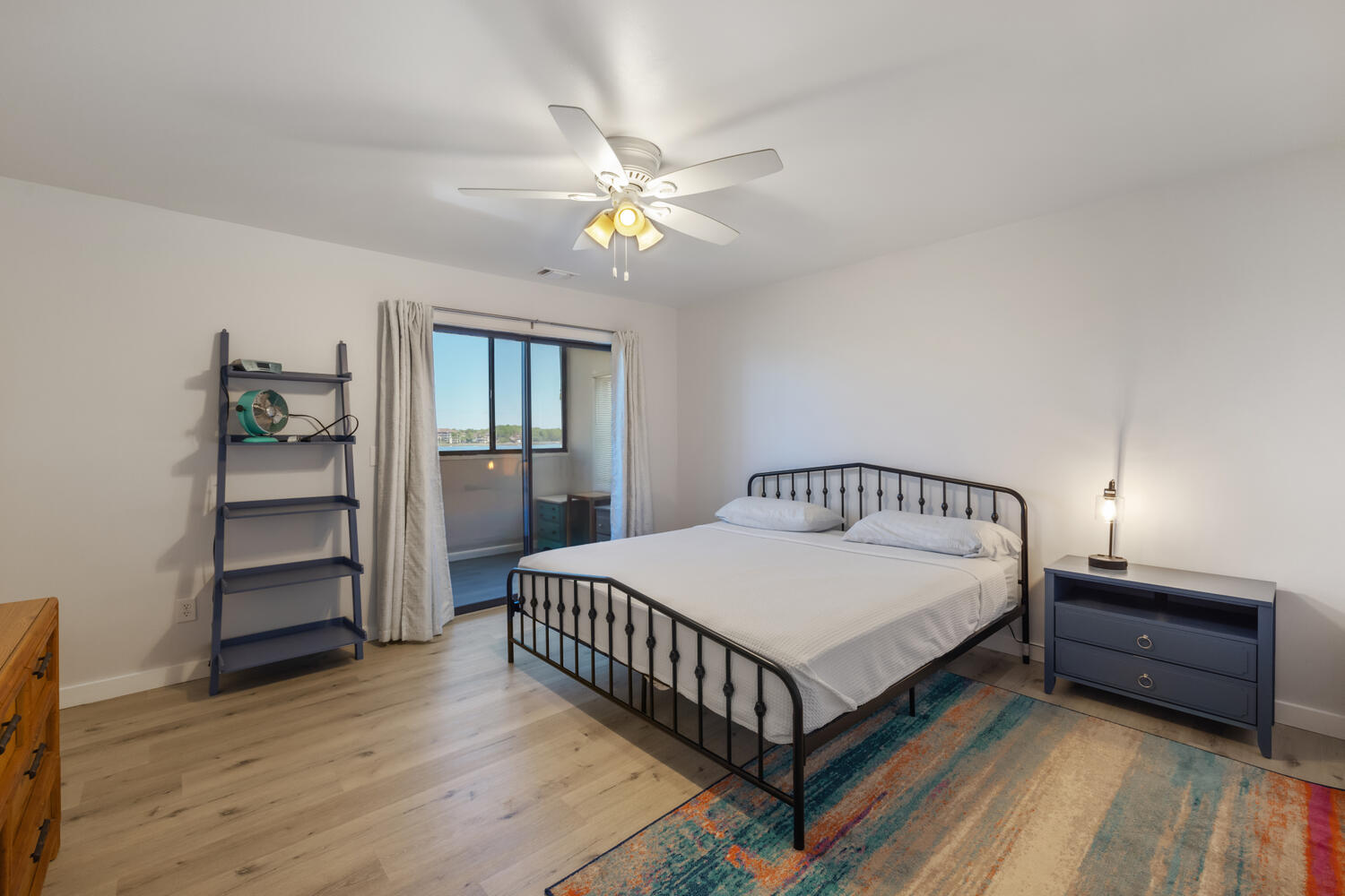 145 Cain Road Panama City Beach, FL 32413 - Photo 35 of 60 a bedroom with a bed and a chandelier