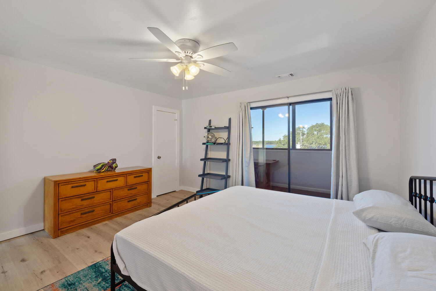 145 Cain Road Panama City Beach, FL 32413 - Photo 36 of 60 a bedroom with a bed and a chandelier