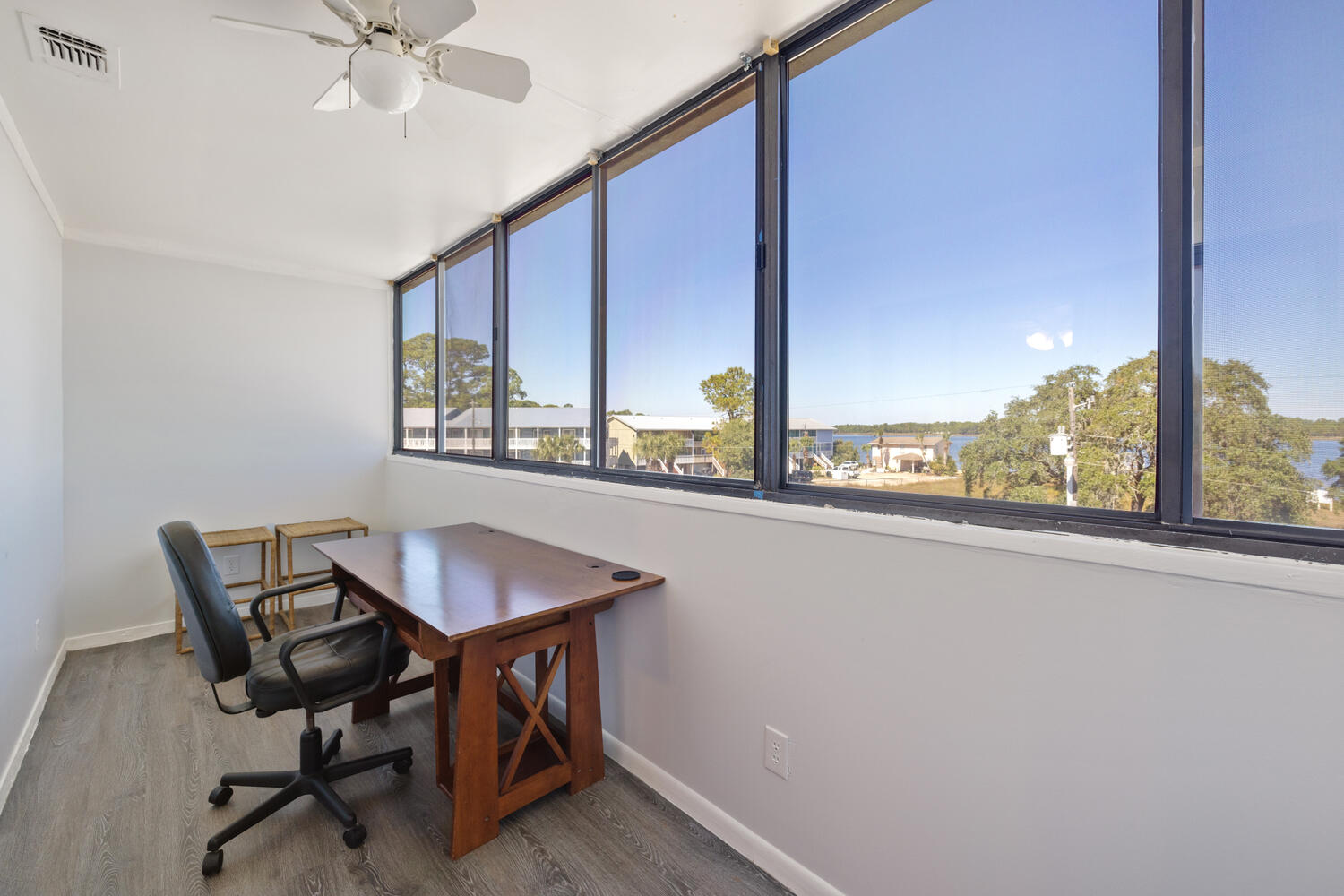145 Cain Road Panama City Beach, FL 32413 - Photo 37 of 60 a view of a dining room with furniture window and wooden floor