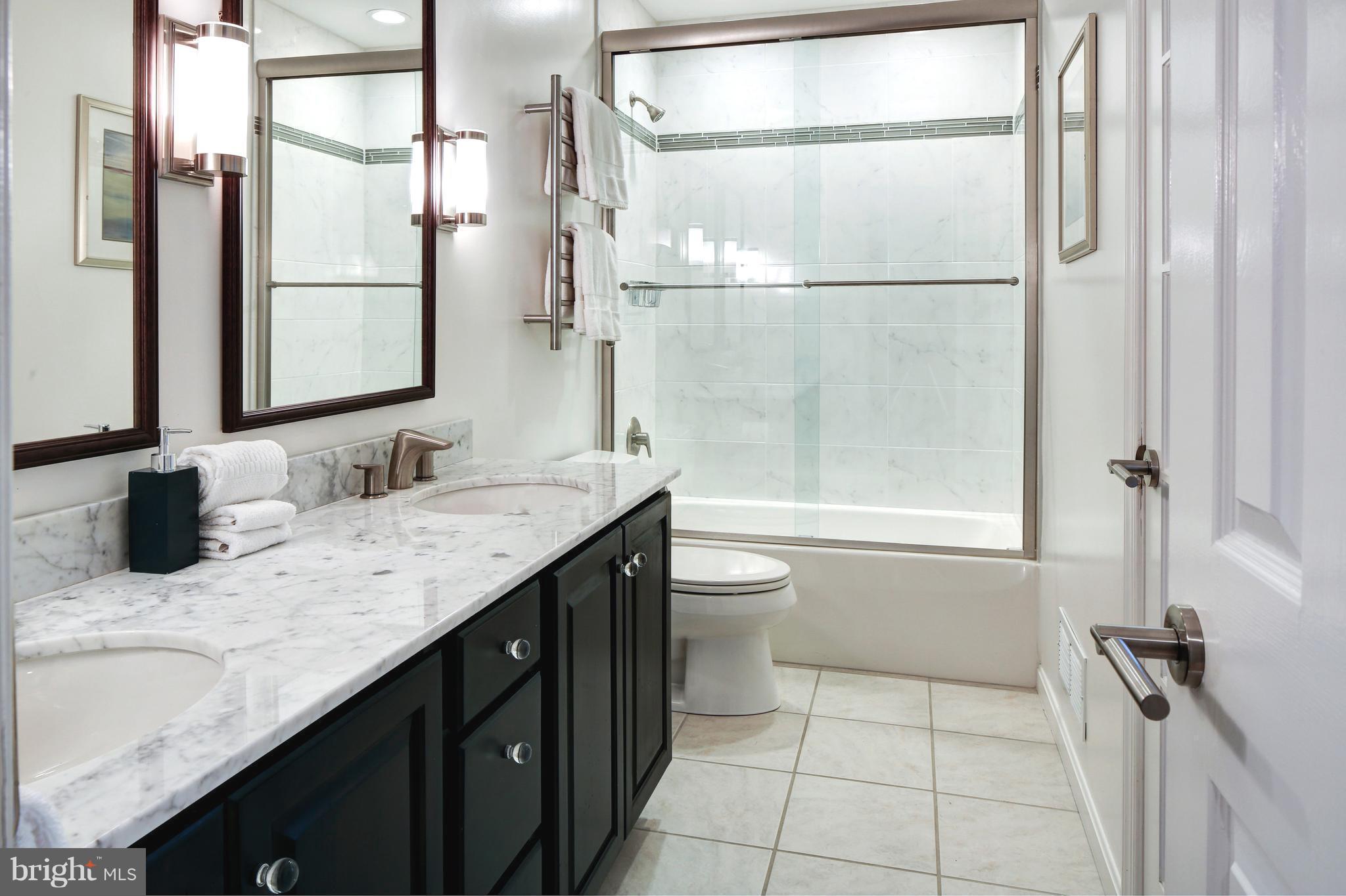 1688 Coventry Place Annapolis, MD 21401 - Photo 24 of 30 a bathroom with a granite countertop sink a toilet and shower