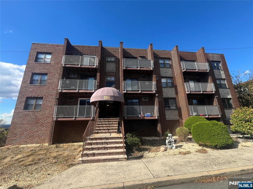 201 12th Street, Unit 6 Palisades Park, NJ 07650 - Photo 2 of 19 a front view of a building with a garden and balcony