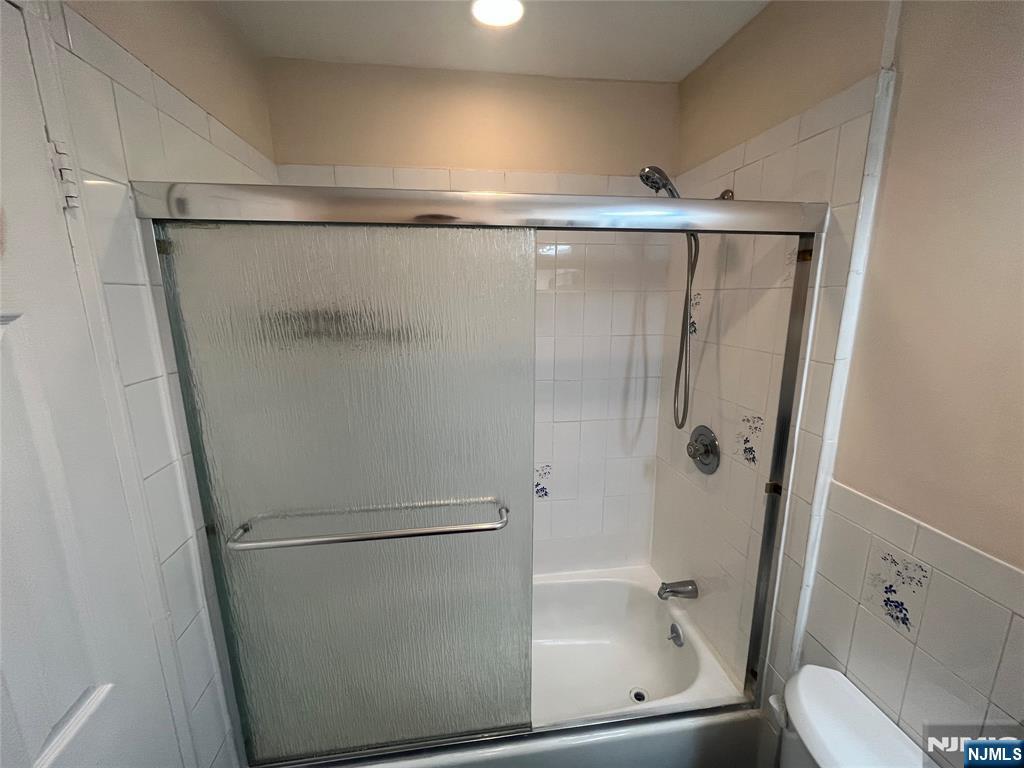 201 12th Street, Unit 6 Palisades Park, NJ 07650 - Photo 10 of 19 a bathroom with a glass shower door