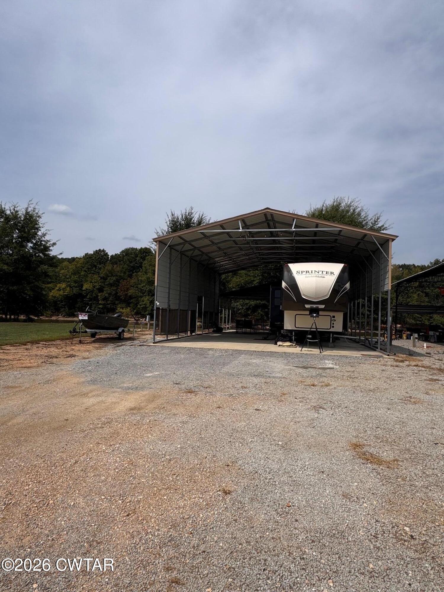 267 Dd Cove Decaturville, TN 38329 - Photo 30 of 60 a front view of house with yard space and trees