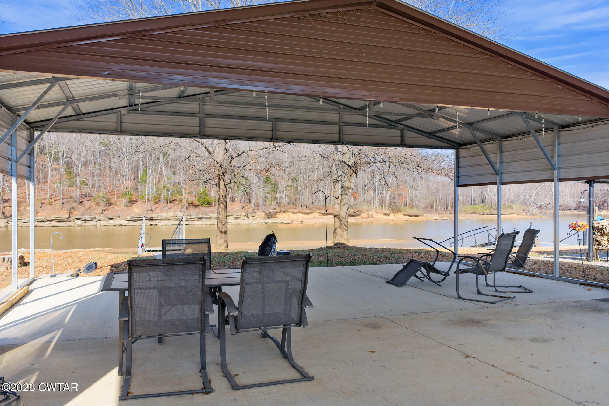267 Dd Cove Decaturville, TN 38329 - Photo 6 of 60 a view of a patio with table and chairs under an umbrella