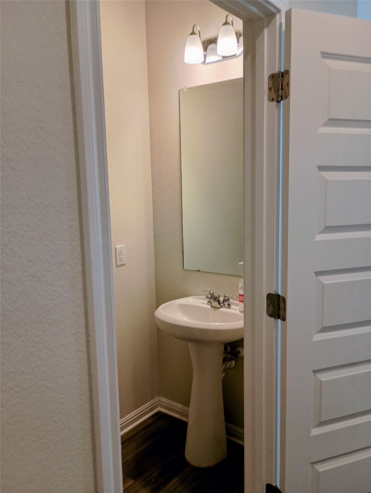 10615 Ridan Way Buda, TX 78610 - Photo 11 of 21 Bathroom with a textured wall and dark wood finished floors
