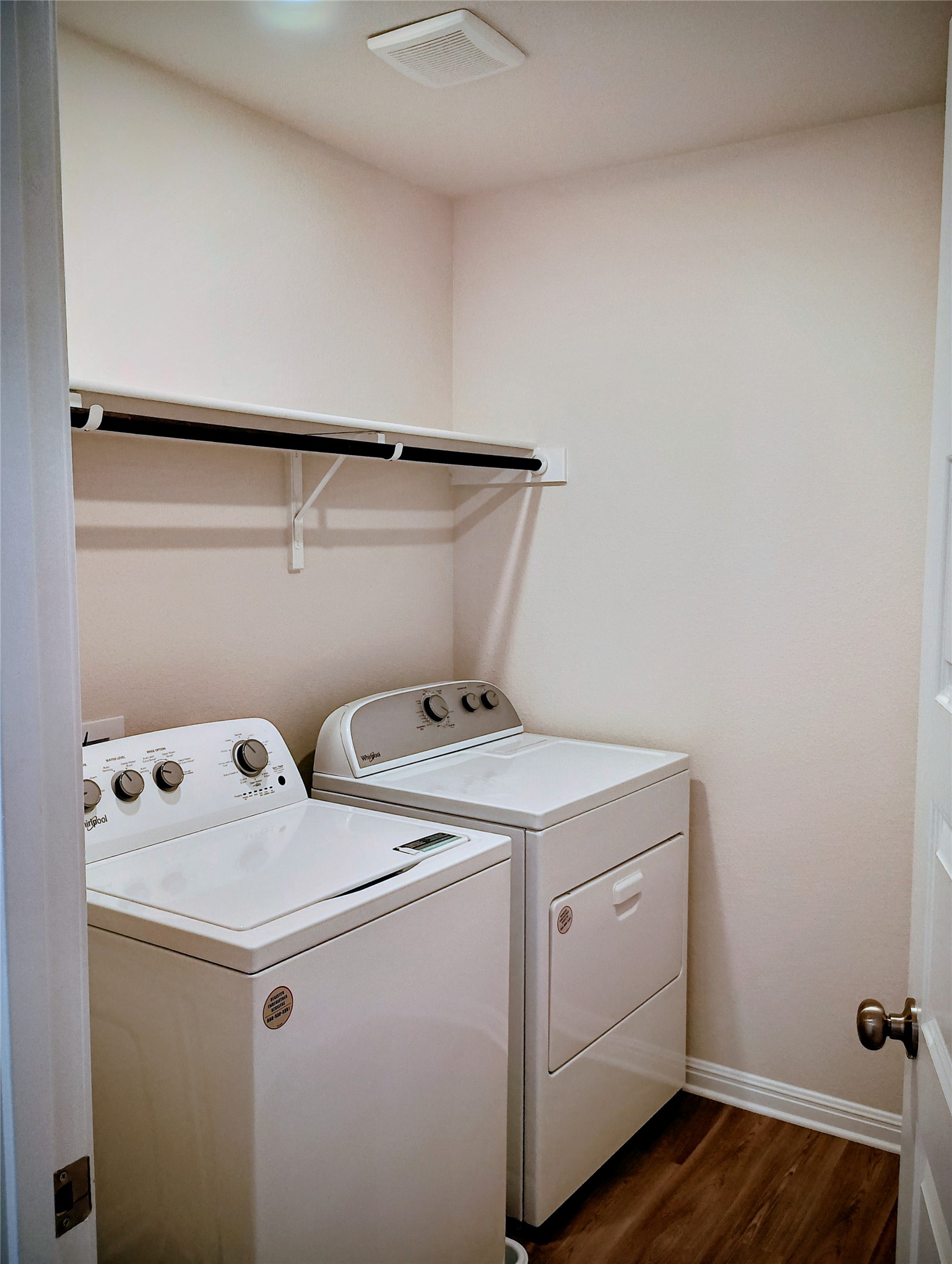 10615 Ridan Way Buda, TX 78610 - Photo 16 of 21 Laundry area featuring dark wood-style floors and washer and clothes dryer