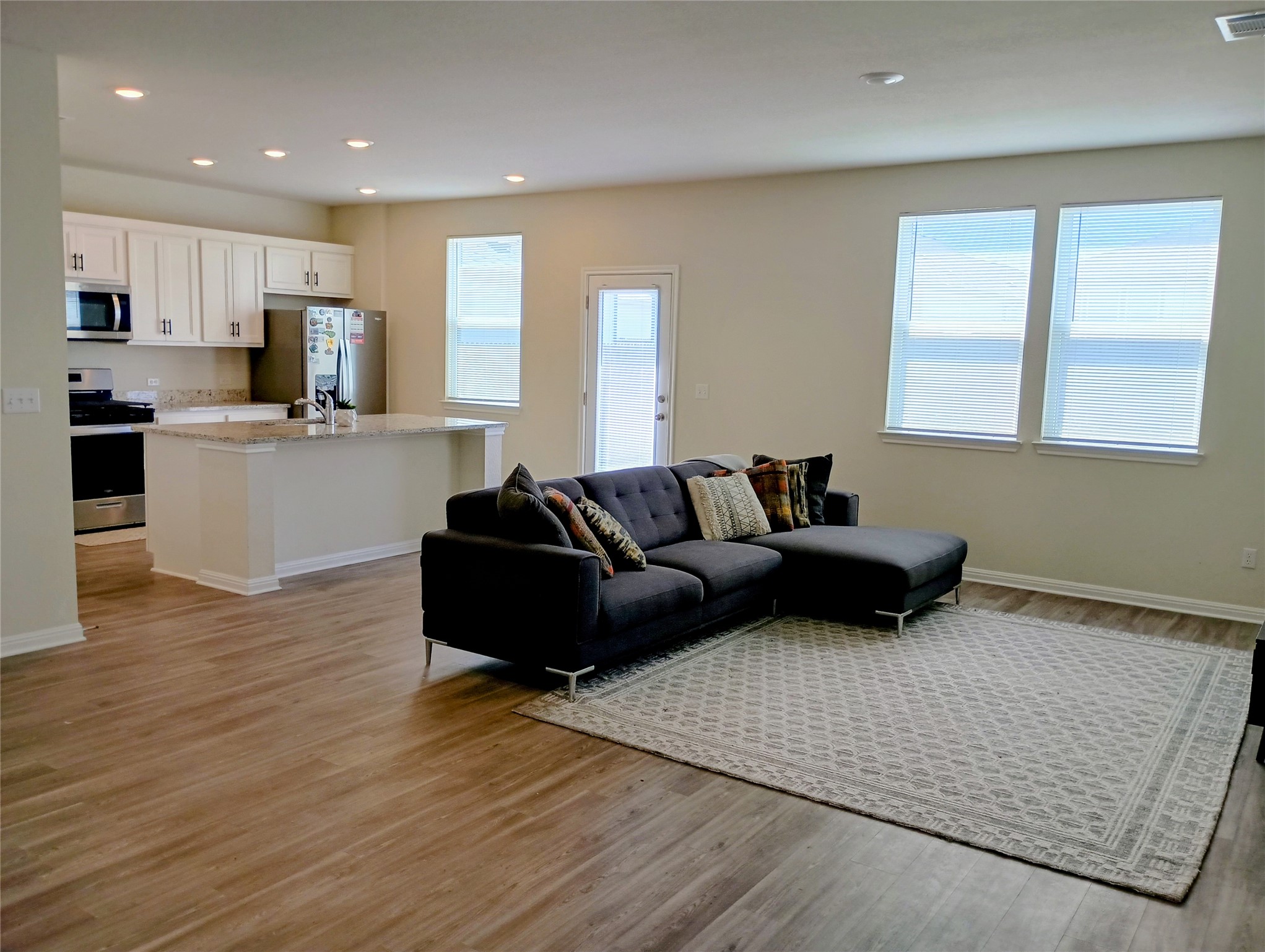 10615 Ridan Way Buda, TX 78610 - Photo 8 of 21 Living area featuring light wood finished floors and recessed lighting