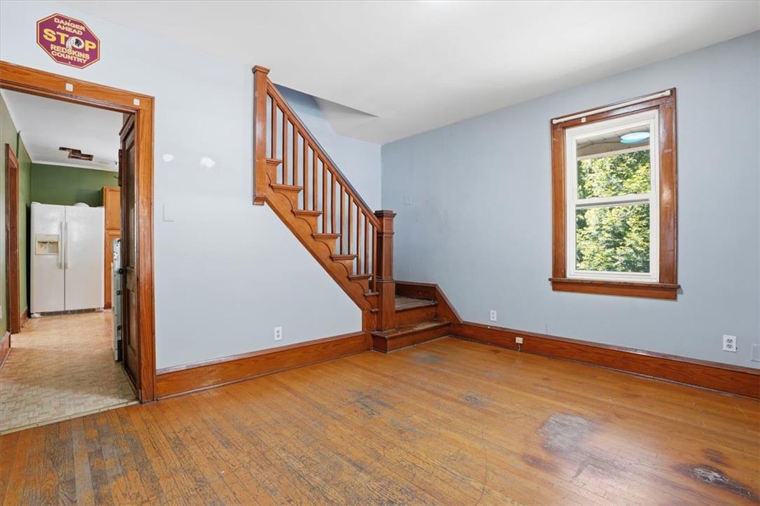 167 Main Road Lehighton, PA 18235 - Photo 4 of 41 Rich hardwood flooring complements the classic wooden staircase and window trim in this versatile room.