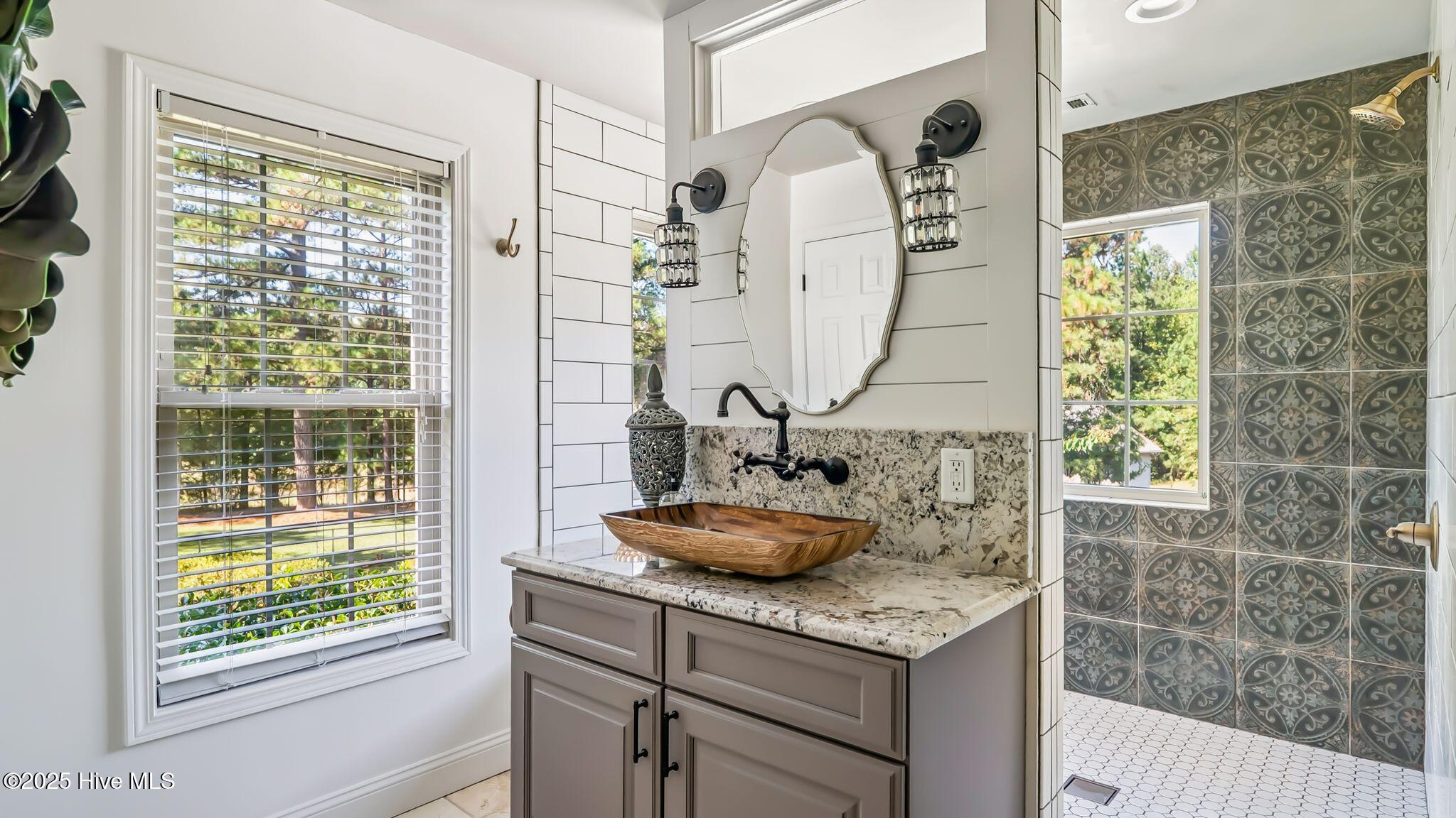 1336 McCaskill Road Carthage, NC 28327 - Photo 38 of 88 Master spa retreat with dual vanities, private water closet, panoramic estate views, and
jetted tub