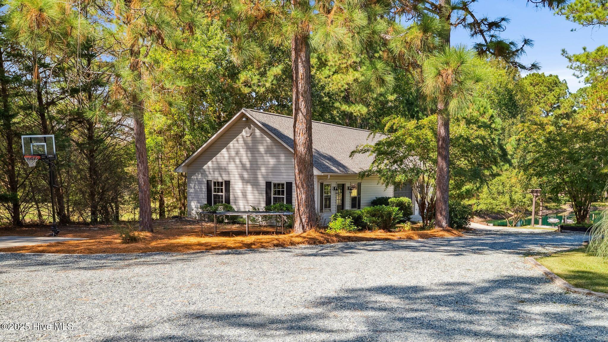 1336 McCaskill Road Carthage, NC 28327 - Photo 63 of 88 1,300 sq ft climate-controlled detached building with dedicated HVAC and electrical panel
ready for office/fitness/entertainment area - pool table to convey
Building includes additional garage parking for 3 cars + UTV/Golf Cart storage, built-in bench
tops and integrated compressor airlines