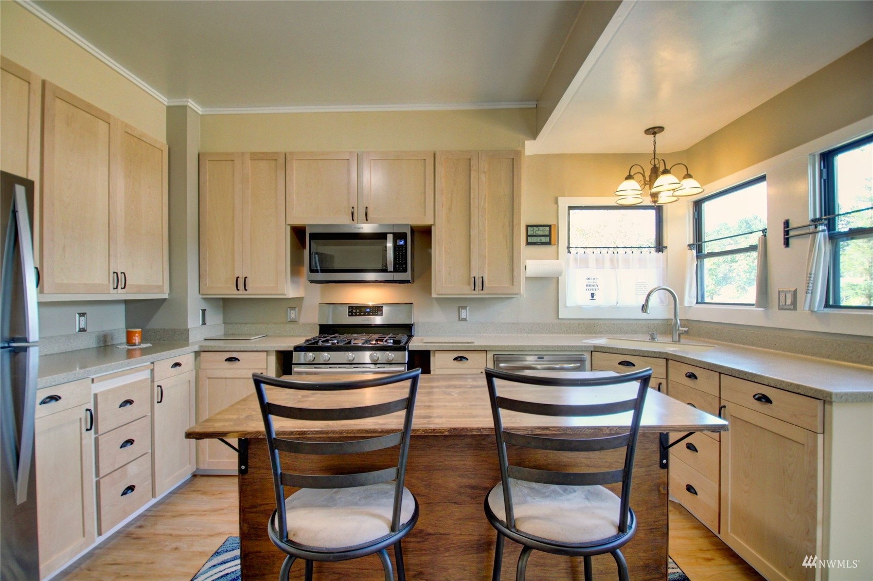 17344 Bennett Road Mount Vernon, WA 98273 - Photo 8 of 31 a kitchen with stainless steel appliances a microwave a stove and white cabinets