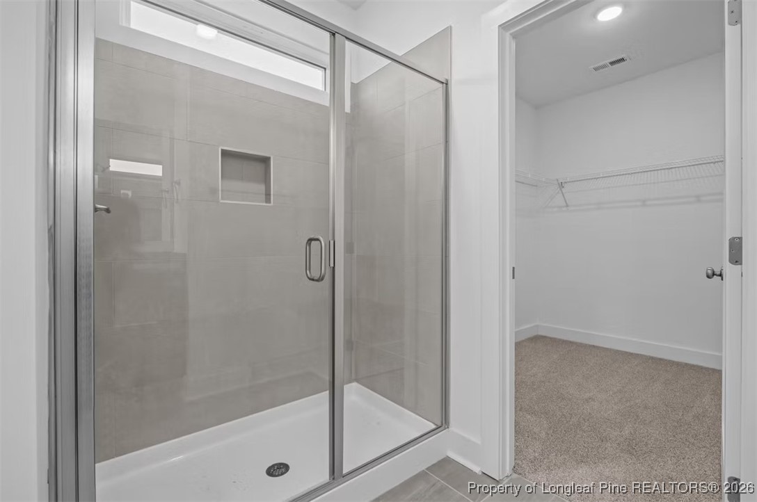 9806 Rockfish Road Raeford, NC 28376 - Photo 11 of 33 a bathroom with a glass shower door