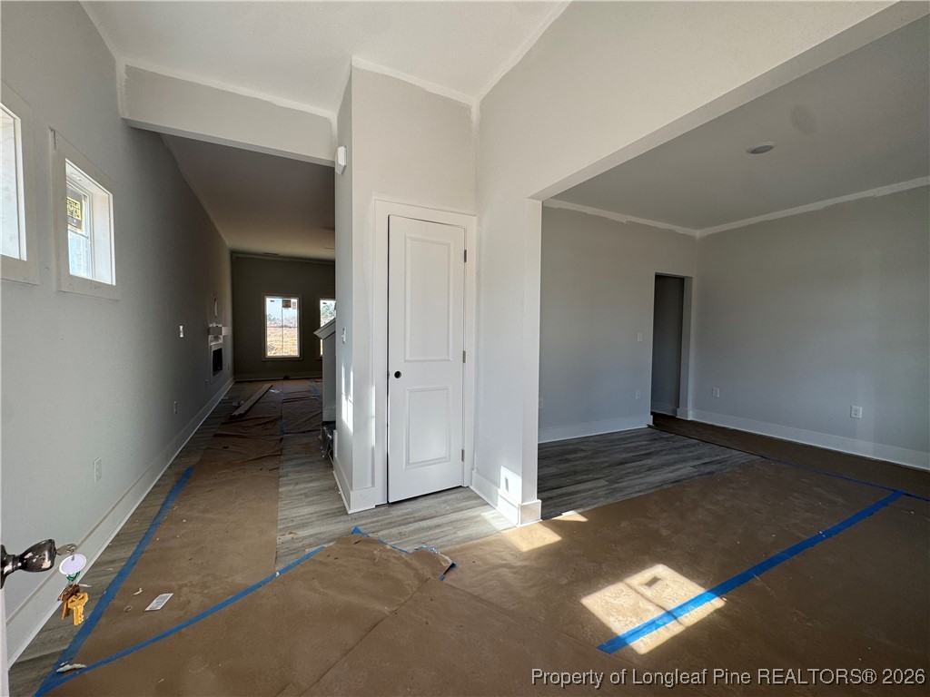 9806 Rockfish Road Raeford, NC 28376 - Photo 21 of 33 an empty room with wooden floor and windows
